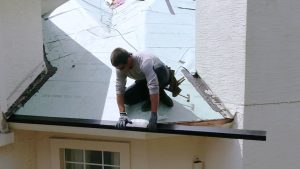 Prime Roofing contractor installing drip edge on Florida roof during replacement