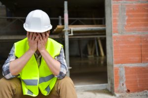 Roofing contractor covering his face after a poor customer experience