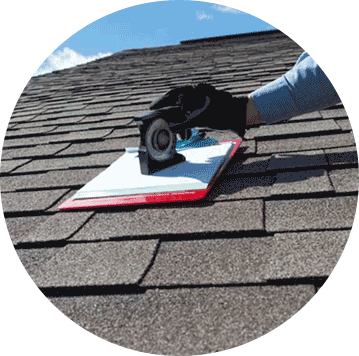 Shingle roof repair in progress with a flat pry bar tool being used