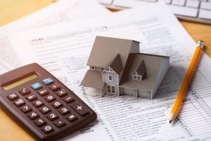 Tax documents and calculator on a desk illustrating home improvement deductions