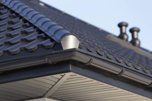 Close-up view of a standing seam metal roof corner with clean vertical seams and modern design, showcasing durable construction under clear Florida skies.