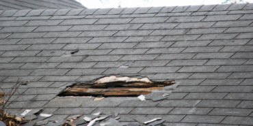 Aged and damaged roof with visible holes indicating the need for roof replacement