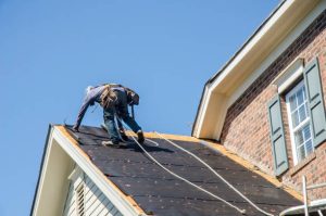 Professional roofing contractors inspecting a residential roof in Jacksonville, FL