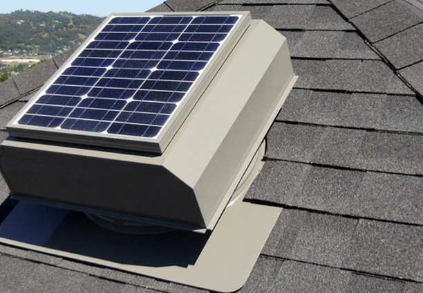 Solar attic fan installed on a grey residential shingle roof in Florida