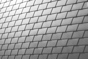Aluminum shingles installed along roof ridge – a type of metal roofing shingle