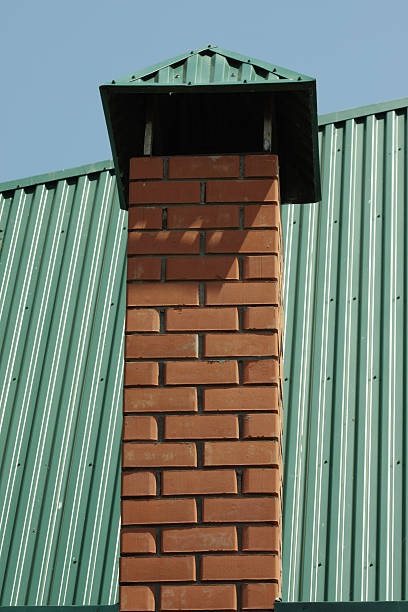 Plain silver aluminum chimney cap example — do roofers install chimney caps