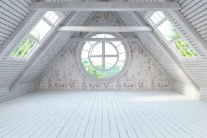 Bright white attic interior showcasing added space after remodeling flat roof to pitched