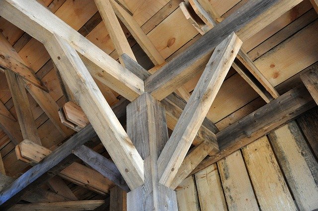 Collar beam connecting opposing rafters in a pitched roof structure