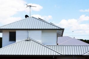 Modern house with complex corrugated metal roofs, ideal for homeowners seeking durable, stylish metal roofing solutions.
