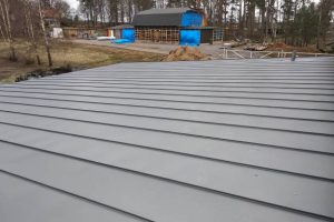 Finished grey metal roof panels installed after the metal roof manufacturing process