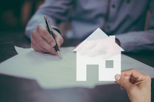Man signing home insurance contract in Florida with virtual house icon overlay