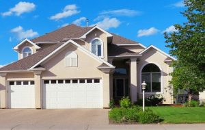Complex multi-level roof with pyramidal hips and gable dormers on a modern home