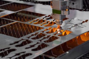 Laser metal cutting machine in action for metal panel manufacturing tools