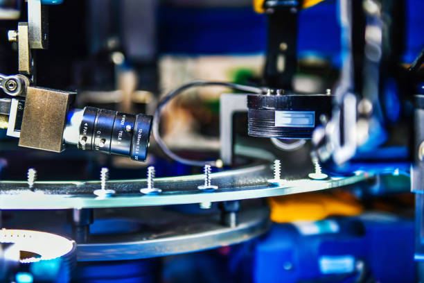 Metal roof components being assembled in a factory using automated machinery