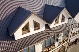 Residential metal roofing panels with attic windows showing energy-efficient home design