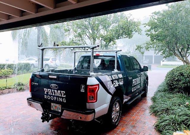Prime Roofing work truck parked in the rain