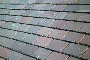 Close-up of natural slate roofing tiles showing texture and color variations