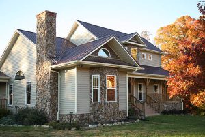 Stone home with complex roofing structure undergoing replacement during COVID-19 precautions