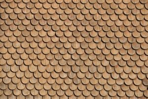 Cedar wood shingles installed in uniform rows – a traditional roofing option