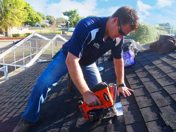 Prime Roofing contractor using nailgun for shingle installation