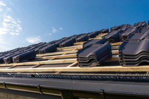 Roof tiles stacked on battens during installation, showing what to expect during tile roof installation on a residential home.