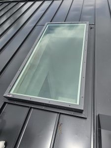 Completed flat metal roof with matte black finish in Miramar Terrace Duval County