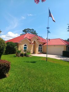 Terracotta striated metal roof installed on residential home in Orange Park Florida replacing old shingle roof