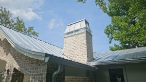 1-inch mill finish ribbon bead metal roof with chimney installed by Prime Roofing in Sawgrass, St. Johns County, Florida.