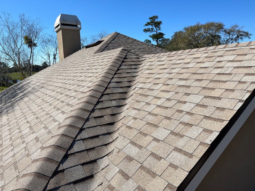 Side view of a newly installed hip roof with Duration Amber shingles showing clean lines and texture.