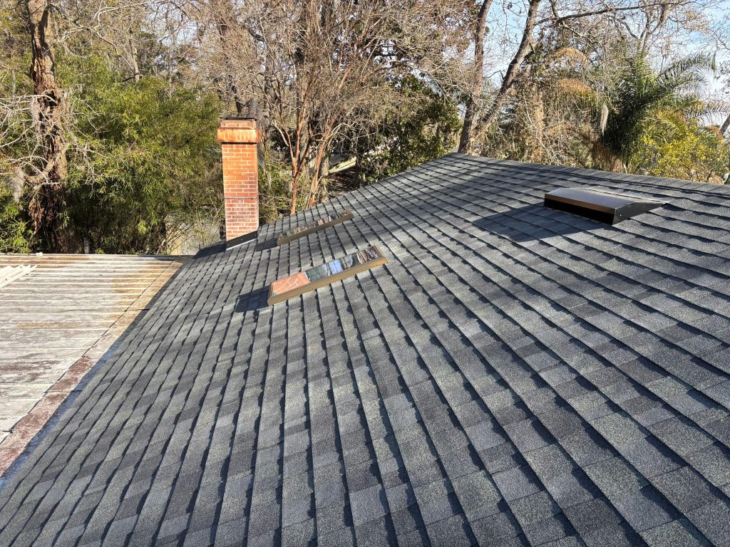 Close-up of Estate Gray shingle ridge caps on a residential roof in Atlantic Beach.