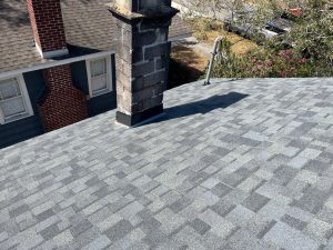 Estate Gray architectural shingle roof installation with chimney flashing detail in Downtown Jacksonville FL