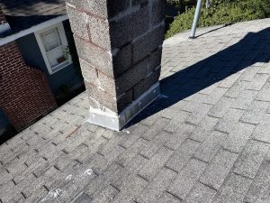 Old asphalt shingle roof around chimney before replacement in Downtown Jacksonville Florida