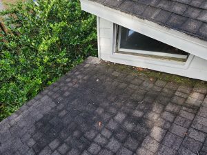 Aging asphalt shingle roof valley before replacement in North Atlantic Beach Florida
