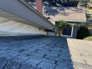 Worn asphalt shingle roof valley before roof replacement in Jacksonville Florida