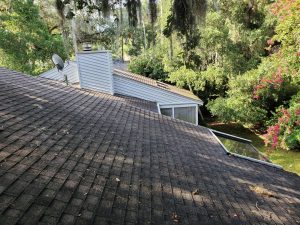 Weathered asphalt shingle roof slope before replacement in Atlantic Beach Florida