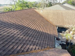 Progress view of an Owens Corning Duration Amber shingle roof installation on a multi-slope home.