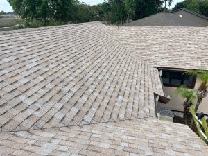 Aging and weathered asphalt shingle roof prior to a full tear-off and replacement in Jacksonville 32225.