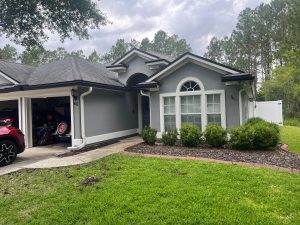 Full exterior view of a St. Augustine home after a complete shingle roof replacement with Onyx Black shingles.
