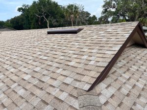Installing high-performance synthetic underlayment over plywood roof deck on a Jacksonville home.