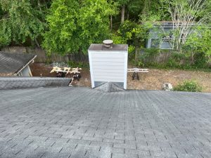 Low-angle view of a weathered, failing residential roof in the 32258 zip code area before tear-off.