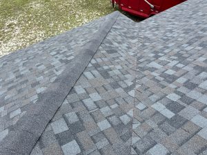 Mid-range angle of a newly installed shingle roof valley and ridge ventilation system in Westside Jacksonville FL.