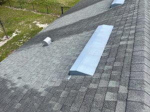 High-angle inspection shot of worn shingle roof slope showing heavy granule loss and aging asphalt surface in Westside Jacksonville.