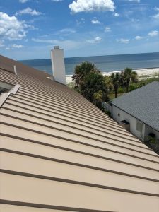 Elevated side profile of new flat panel Sierra Tan standing seam metal roof in Ponte Vedra Beach FL
